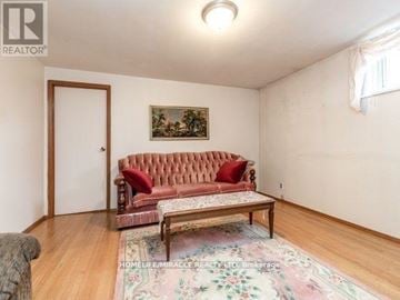 Toronto (Bendale) apartment for rent - A living room with a red sofa and a painting on the wall.
