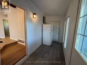 Ramara apartment for rent - A white door is in a hallway with wood floors.