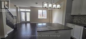 Milton (Ha Harrison) townhouse for rent - A kitchen with a granite countertop and a staircase with black railings.