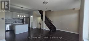 Milton (Ha Harrison) townhouse for rent - A spacious kitchen with a bar and a staircase in the background.
