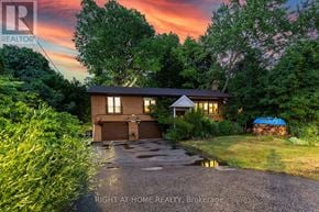 Toronto (Bendale) apartment for rent - A house with a driveway and a sunset in the background.