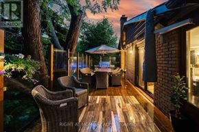 Toronto (Bendale) apartment for rent - A patio with a table and chairs is set up outside a house.