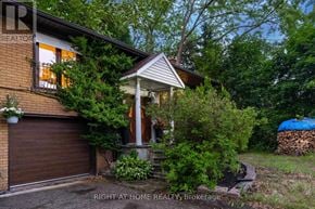Toronto (Bendale) apartment for rent - A house with a brown garage door and a porch with a white railing.