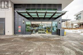 Mississauga (City Centre) condo for rent - The entrance to a building with a glass door and a sign that reads "REALTOR".
