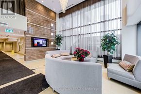 Mississauga (City Centre) condo for rent - A living room with a grey couch, a flat screen TV, and a plant.