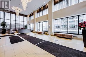 Mississauga (City Centre) condo for rent - A large, well-lit lobby with a reception desk and seating area.