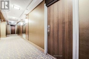 Mississauga (City Centre) condo for rent - A hallway with a wooden door and tiled floor.