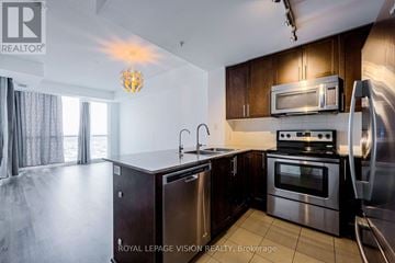Mississauga (City Centre) condo for rent - A kitchen with a stainless steel refrigerator, microwave, and oven.