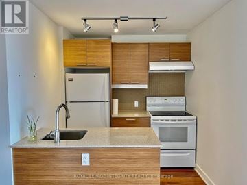 Ottawa condo for rent - A kitchen with a sink, stove, and refrigerator.