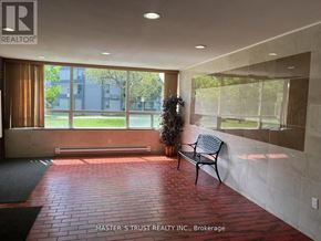 Toronto (Scarborough Village) condo for rent - A bench is placed in the middle of a hallway with a brick floor.