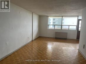 Toronto (Scarborough Village) condo for rent - A room with wooden flooring and white walls, with a window and a radiator.
