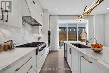 Richmond Hill apartment for rent - A modern kitchen with white cabinets and a marble countertop.