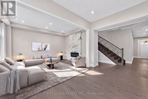 Richmond Hill apartment for rent - A spacious living room with a staircase leading to the upper floor.