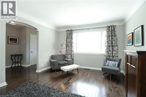 Burlington apartment for rent - A living room with a grey couch and a wooden floor.