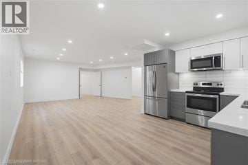 Burlington apartment for rent - A modern kitchen with stainless steel appliances and wooden flooring.