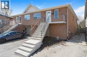 Burlington apartment for rent - A two-story brick house with a car parked in front.