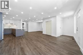 Burlington apartment for rent - A spacious room with wooden flooring and white walls.