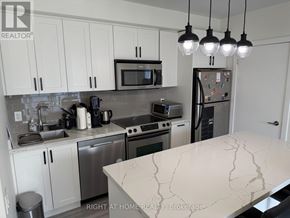 Toronto (Church-Yonge Corridor) condo for rent - A kitchen with a marble counter top and stainless steel appliances.