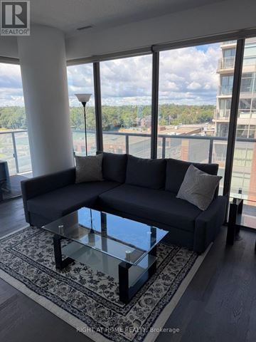 Toronto (Mount Pleasant West) condo for rent - A living room with a large couch and a glass table.
