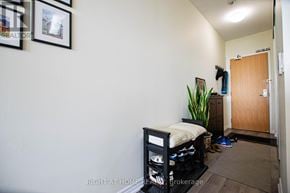 Toronto (Woburn) condo for rent - A room with a bed, a plant, and a door.