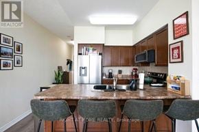 Toronto (Woburn) condo for rent - A kitchen with a table and chairs in front of it.