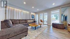 Orillia apartment for rent - A living room with a grey couch and a wooden coffee table.