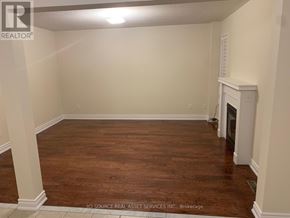 Mississauga (East Credit) apartment for rent - A room with a fireplace and wood flooring.