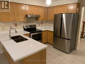 Mississauga (East Credit) apartment for rent - A kitchen with a stainless steel refrigerator, oven, and sink.