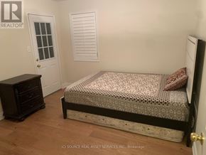 Mississauga (East Credit) apartment for rent - A bedroom with a bed, dresser, and window.