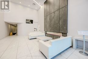 Hamilton (Central) condo for rent - A white reception area with a large screen and a white reception desk.