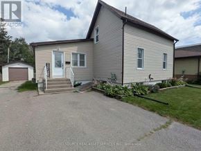 Belleville (Belleville Ward) apartment for rent - A house with a grey siding and a white door is for sale.