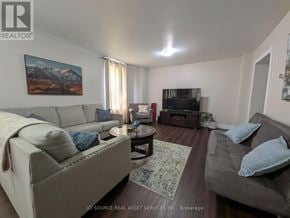 Belleville (Belleville Ward) apartment for rent - A living room with a grey couch, a white couch, and a rug.