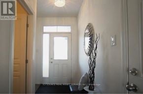 Ottawa townhouse for rent - A hallway with a light on the ceiling and a sculpture on the floor.