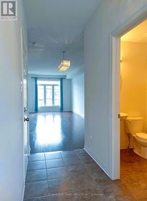 Ottawa townhouse for rent - A bathroom with a toilet and a window.
