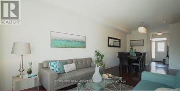 Ottawa townhouse for rent - A living room with a grey couch and a painting on the wall.