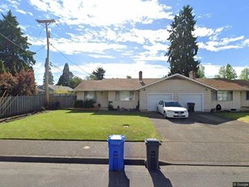 Eugene apartment for rent - A white car is parked in the driveway of a house.