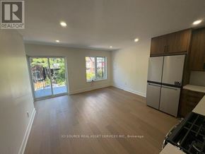 Toronto (University) apartment for rent - A spacious kitchen with wooden floors and a refrigerator.