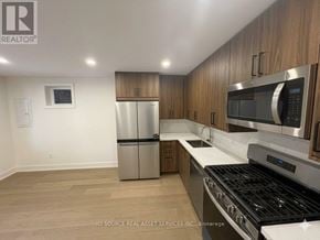 Toronto (University) apartment for rent - A kitchen with a stainless steel refrigerator, microwave, and oven.