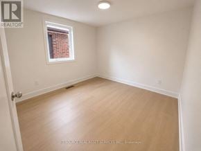 Toronto (University) apartment for rent - A room with a window and wooden flooring.