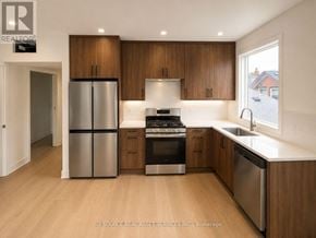 Toronto (University) apartment for rent - A modern kitchen with wooden cabinets and stainless steel appliances.
