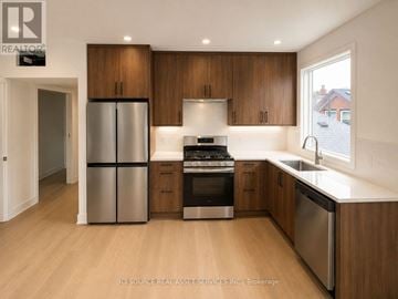 Toronto (University) apartment for rent - A modern kitchen with wooden cabinets and stainless steel appliances.