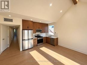 Toronto (University) apartment for rent - A kitchen with wooden cabinets and stainless steel appliances.