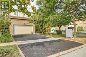 Mississauga (Meadowvale) apartment for rent - A residential area with a house, garage, and trees.