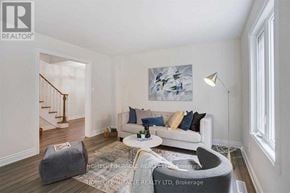 Mississauga (Meadowvale) apartment for rent - A living room with a couch, a chair, a rug, and a painting on the wall.
