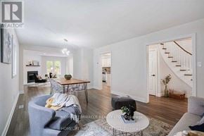 Mississauga (Meadowvale) apartment for rent - A living room with a grey couch, a coffee table, and a staircase in the background.