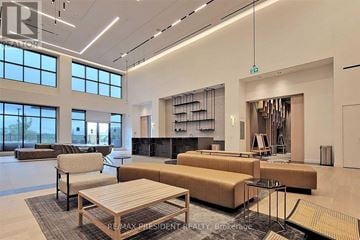 Toronto (Downsview-Roding-Cfb) condo for rent - A modern living room with a large sectional sofa and a coffee table.