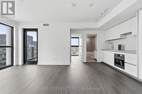 Toronto (Thorncliffe Park) condo for rent - A spacious, modern kitchen with white cabinets and a large island.