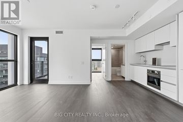Toronto (Thorncliffe Park) condo for rent - A spacious, modern kitchen with white cabinets and a large island.