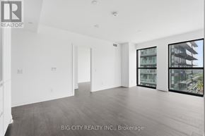 Toronto (Thorncliffe Park) condo for rent - A spacious room with a view of a building through the windows.