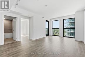 Toronto (Thorncliffe Park) condo for rent - A spacious, well-lit room with a view of a building outside the window.